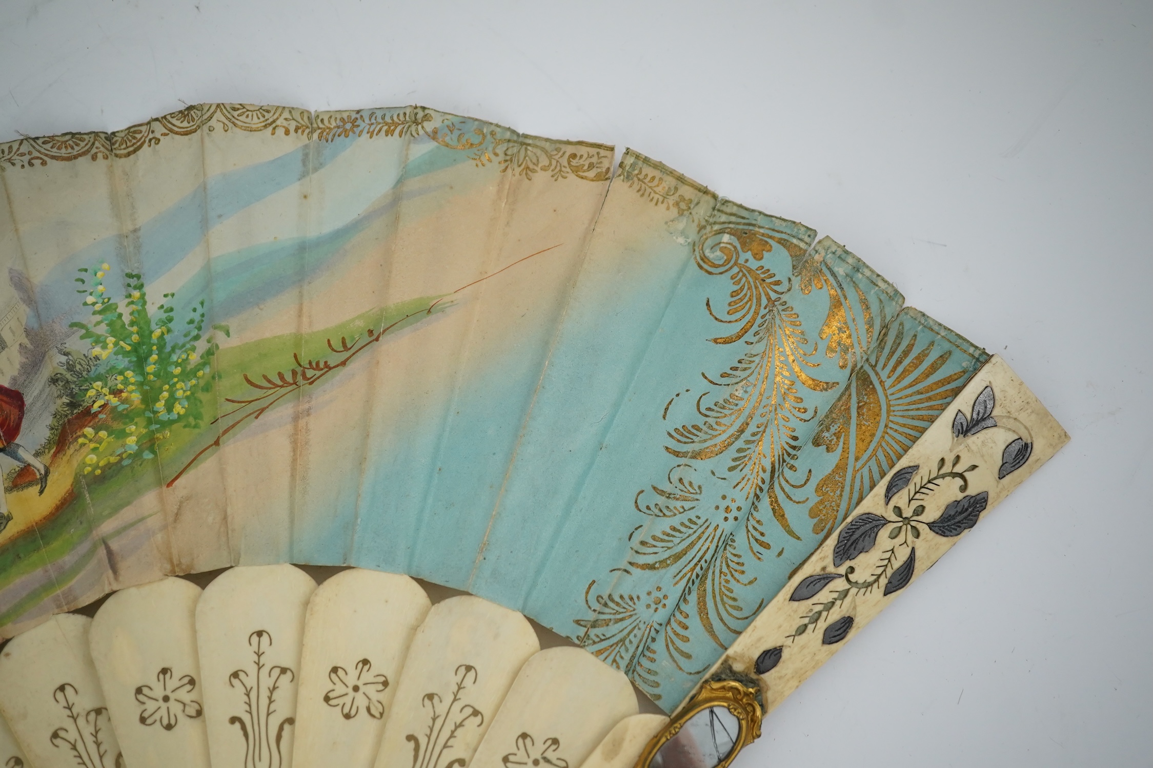 Three French fans: a mother of pearl and sequin fan boxed, a painted silk, feather and bone fan and a gilt decorated bone figural paper fan, the two bone fans having gilt mirrored mounts on the guards, figural paper fan